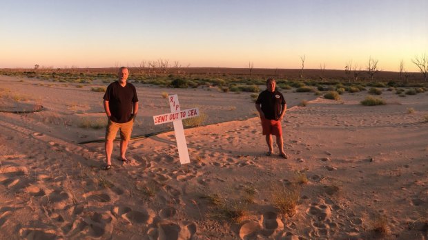 Ross Leddra outside his home on Sunset Strip last year when the Lake Menindee was bone dry. Now the lake is filling up quickly, bringing spiders and mosquitoes. 