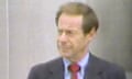 man wearing black suit, blue shirt and red tie