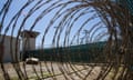 FILE - In this April 17, 2019, photo, reviewed by U.S. military officials, the control tower is seen through the razor wire inside the Camp VI detention facility in Guantanamo Bay Naval Base, Cuba. A military medical panel has concluded that one of the five 9/11 defendants held at Guantanamo Bay has been rendered delusional and psychotic by the torture he underwent years ago while in CIA custody. A military judge is expected to rule as soon as Thursday whether al-Shibh’s mental issues render him incompetent to take part in the proceedings against him. (AP Photo/Alex Brandon, File)