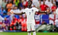 Gareth Southgate talks to Bukayo Saka on the sidelines during the last 16 game between England and Slovakia