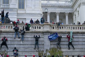 In this Jan. 6, 2021 file photo, rioters climb the west wall of the the U.S. Capitol in Washington. First, some blamed the deadly Jan. 6 attack on the Capitol on left-wing Antifa antagonists, a theory quickly debunked. Then came comparisons of the rioters as peaceful protesters, or even “tourists." Now, Trump allies rallying in support of those people charged in the Capitol riot are calling them “political prisoners," a stunning effort to revise the narrative of that deadly day.