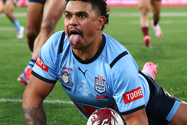 Latrell Mitchell of the Blues celebrates scoring a try.