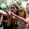 Protesters shoot water from water guns at tourists during a protest against mass tourism in Barcelona