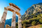 A greek temple at the base of a mountain range sundec8greece Greece ancient Olympia Peloponnese region Olympics ; text by Steve McKenna ; iStock *** REUSE PERMITTED ***Â 