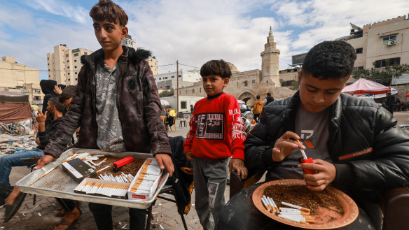 Palestinian youths sell cigarettes on a main square in Khan Younis in November.