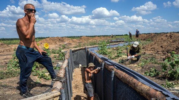 Workers install a trench line in the Donetsk region of eastern Ukraine.