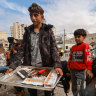 Palestinian youths sell cigarettes on a main square in Khan Younis in November.