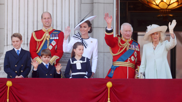 Prince George, Prince William, Prince Louis, Princess Charlotte, Princess Catherine, King Charles and Queen Camilla wave from the Buckingham Palace balcony.