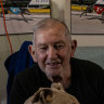 Greyhound trainer Luke Azzopardi with Ollie Impact at his Londonderry kennels.