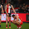 Double trouble: Josh Battle consoles Sydney’s Logan McDonald after St Kilda’s upset win.