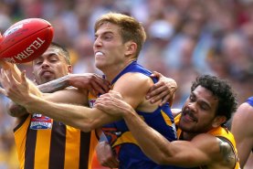 MELBOURNE, AUSTRALIA - OCTOBER 03:  Brad Sheppard of the Eagles handballs whilst being tackled by Bradley Hill and Cyril Rioli of the Hawks  during the 2015 AFL Grand Final match between the Hawthorn Hawks and the West Coast Eagles at Melbourne Cricket Ground on October 3, 2015 in Melbourne, Australia.  (Photo by Quinn Rooney/Getty Images)