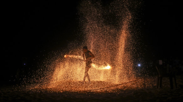 A fire dancer performs during a show for tourists on Batu Ferringhi Beach on Penang Island, Malaysia.