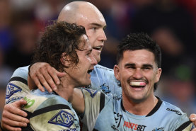 Daniel Atkison (right), Nicho Hynes and Tom Hazleton (centre) celebrate a try against the Roosters.