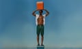 Model standing on an cooler holding a cooler above head