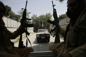 FILE - Taliban fighters patrol in Kabul, Afghanistan, on Aug. 19, 2021. Human Rights Watch said Monday, Feb. 12, 2024 that Afghanistan’s public health system has been hit hard following a sharp reduction in foreign assistance, coupled with serious Taliban abuses against women and girls, jeopardizing the right to healthcare of millions of Afghans.