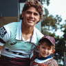 North Devils under-6s player Oscar White, the 200,000th player registered to play rugby league in Australia in 2024, with Brisbane Broncos fullback Reece Walsh.