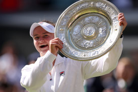 Barbora Krejcikova of Czechia lifts the trophy following victory against Jasmine Paolini of Italy.