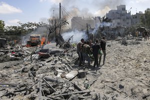 Palestinians evacuate a body from a site hit by an Israeli bombardment on Khan Younis, southern Gaza Strip, Saturday, July 13, 2024. Israel said it targeted Hamas' shadowy military commander in a massive strike Saturday in the crowded southern Gaza Strip that killed at least 71 people, according to local health officials. Hamas immediately rejected the claim that Mohammed Deif was targeted.