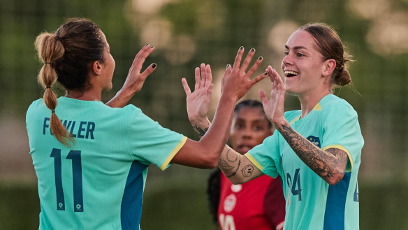 Sharn Freier celebrates with Mary Fowler after scoring Australia’s goal against Canada.