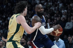 NBA legend LeBron James looks for a way past the Boomers’ Josh Giddey.