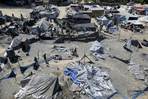 Palestinians inspect the damage at a site hit by an Israeli bombardment on Khan Younis, southern Gaza Strip, Saturday, July 13, 2024. Israel said it targeted Hamas’ shadowy military commander in a massive strike Saturday in the crowded southern Gaza Strip that killed at least 71 people, according to local health officials. Hamas immediately rejected the claim that Mohammed Deif was in the area.