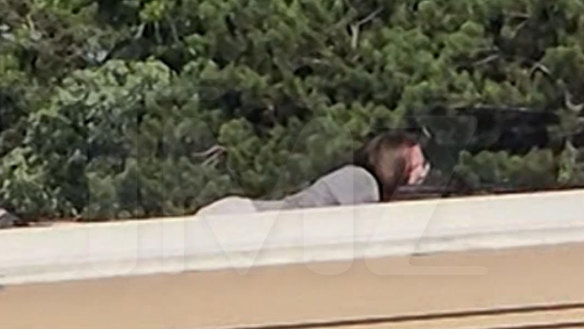 A screen grab from a video shot by a bystander and sourced by celebrity website TMZ shows the shooter – Thomas Matthew Crooks – on a rooftop.