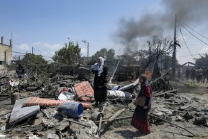 Palestinians inspect the damage at a site hit by an Israeli bombardment on Khan Younis, southern Gaza Strip, Saturday, July 13, 2024. Israel said it targeted Hamas' shadowy military commander in a massive strike Saturday in the crowded southern Gaza Strip that killed at least 71 people, according to local health officials. Hamas immediately rejected the claim that Mohammed Deif was targeted.