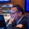 A trader works on the floor of the New York Stock Exchange in June.