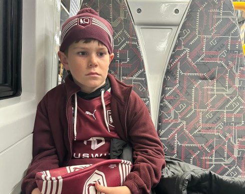 A devastated 11-year-old Carter McPherson on the train home from Suncorp Stadium.