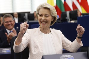 European Commission President Ursula von der Leyen, right, reacts after the announcement of the vote at the European Parliament in Strasbourg, eastern France, Thursday, July 18, 2024. Lawmakers at the European Parliament have re-elected Ursula von der Leyen to a second 5-year term as president of the European Union's executive commission. The re-election ensures leadership continuity for the 27-nation bloc as it wrestles with crises ranging from the war in Ukraine to climate change, migration and housing shortages.