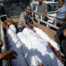 Palestinians gather near the bodies of relatives killed in the Israeli bombardment of Deir al-Balah.