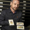 Australian War Memorial curator Garth O’Connell with the 1916 postcards linked to Indigenous WWI soldier Charlie Runga.