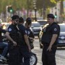 Police stands guard near Louis Vuitton store after a police officer was injured in an attack in the Champs Elysees shopping district in Paris, France. 