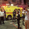 People gather at the scene of an deadly explosion in Tel Aviv.