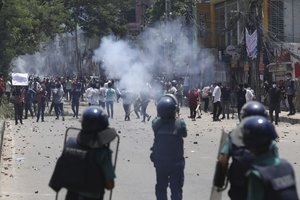 Students clash with riot police during a protest against a quota system for government jobs, in Dhaka, Bangladesh, Thursday, July 18, 2024.