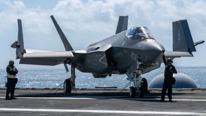 Sailors prepare to taxi an F-35C Lightning II on aircraft carrier USS Carl Vinson