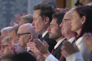 Elon Musk, center, stands up to applaud Israeli Prime Minister Benjamin Netanyahu's remarks during a joint meeting of Congress at the Capitol in Washington, Wednesday, July 24, 2024.