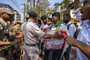 Police stop students trying take out a protest against the Citizenship Amendment Act (CAA) in Guwahati, India, Tuesday, March 12, 2024. India has implemented a controversial citizenship law that has been widely criticized for excluding Muslims, a minority community whose concerns have heightened under Prime Minister Narendra Modi’s Hindu nationalist government. The act provides a fast track to naturalization for Hindus, Parsis, Sikhs, Buddhists, Jains and Christians who fled to Hindu-majority India from Afghanistan, Bangladesh and Pakistan before Dec. 31, 2014.