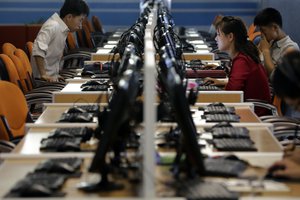 FILE - In this June 16, 2017, file photo, North Korean men and women use computer terminals at the Sci-Tech Complex in Pyongyang, North Korea.