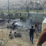 Residents rush to help injured children moments after a rocket attack hit a soccer field in the Druze town of Majdal Shams in the Israeli-controlled Golan Heights.