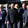 Witness Constable Randall Kirk (centre) is seen arriving at the Brisbane Coroners Court to give evidence at the Wieambilla inquest.