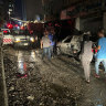 People walk near the building that was hit by an Israeli airstrike in the southern suburbs of Beirut, Lebanon.