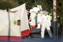 Police and forensic officers attend the scene of the attack.