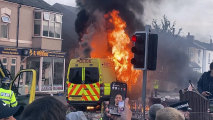 A police van buns as and unruly crowd clashed with police.