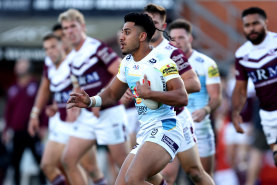 Alofiana Khan-Pereira of the Titans runs the ball against Manly.