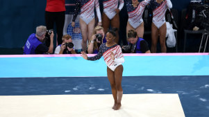 Simone Biles of Team United States reacts after finishing her routine in the floor exercise while teammates Jade Carey, Jordan Chiles, Hezly Rivera and Sunisa Lee cheer.