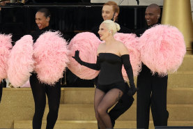 Lady Gaga perform amid a cloud of pom poms.