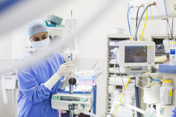 Generic. A nurse checks a saline bag. Photo via iStock. Medical equipment facemask hospital care conditions