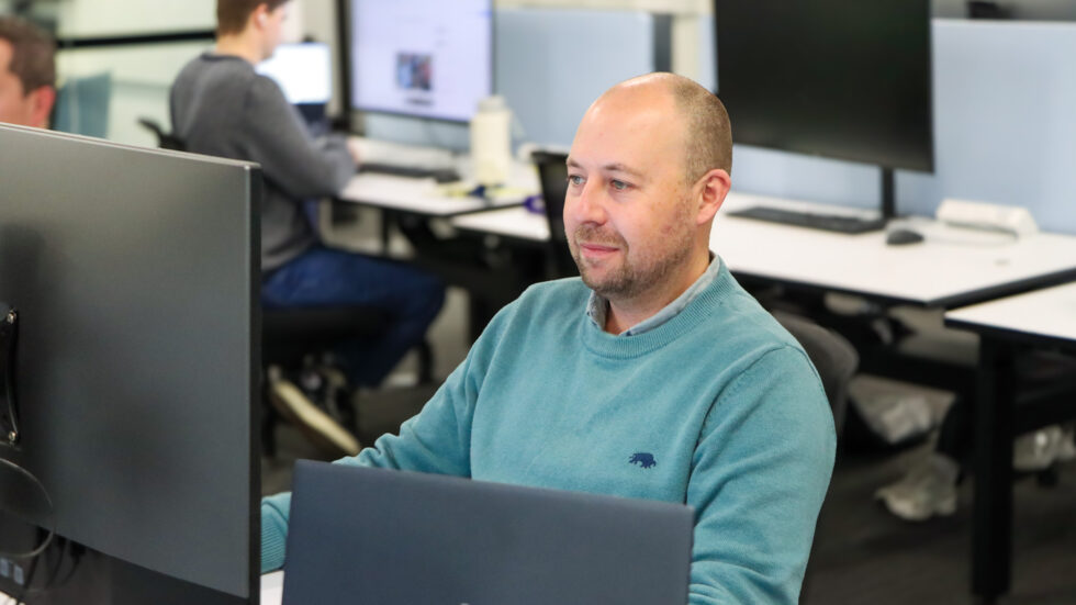 Ben Glover, Editor of wwos.com.au working at his desk