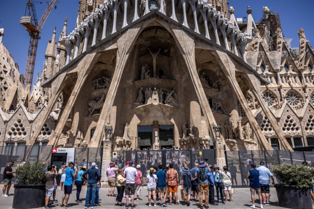 Tourists visit the Sagrada Familia church in Barcelona.